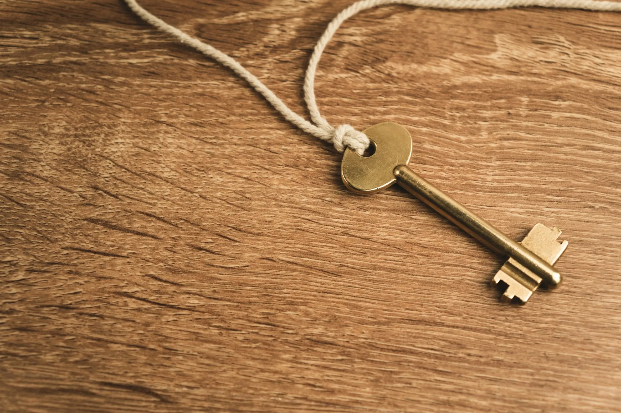 Old brass key on a wooden table, illustrating mortgage protection insurance vs term life for a Vernon Hills home