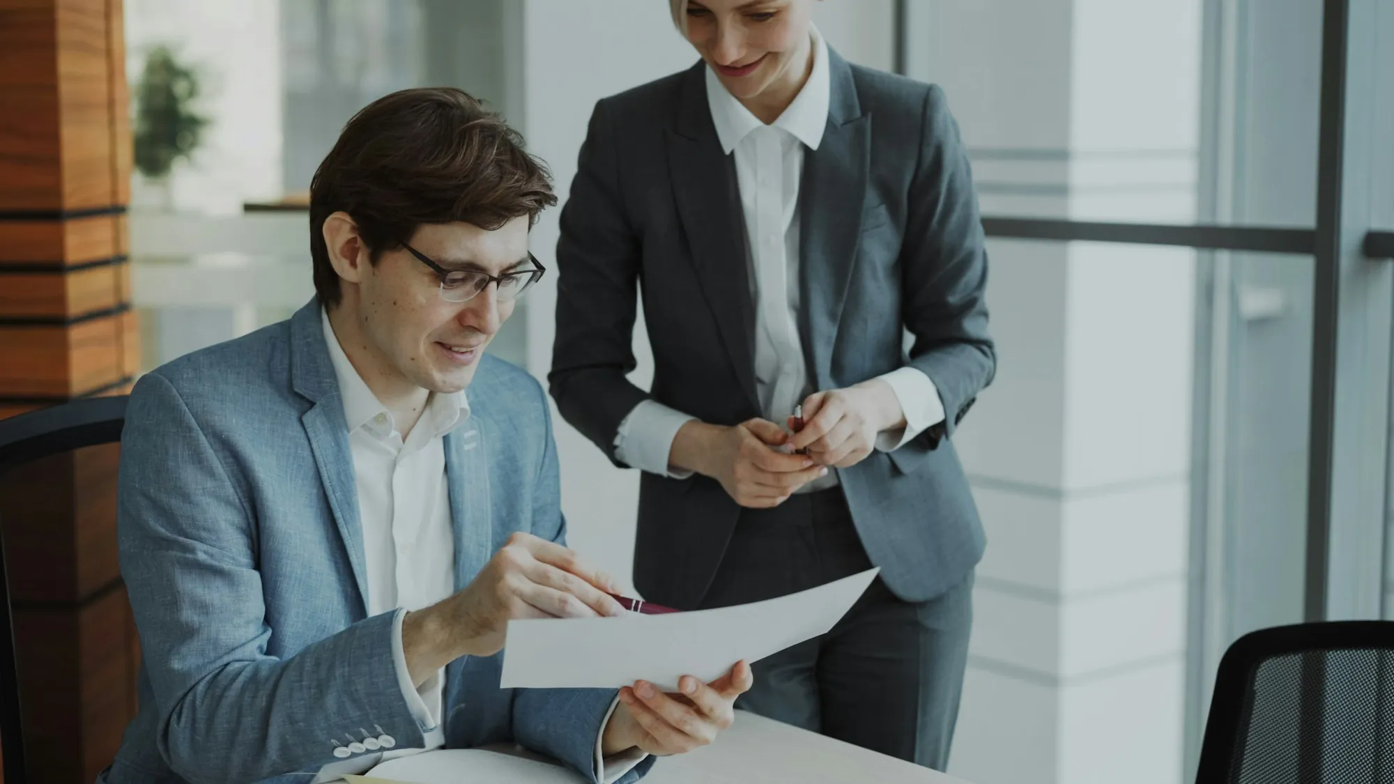 Two colleagues reading a document together